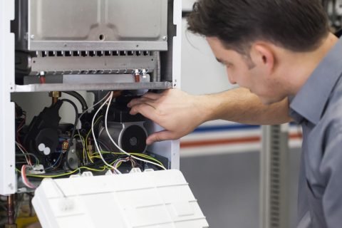 Technician-servicing-heating-boi Affordable Ventilation Systems Services In Tucker GA