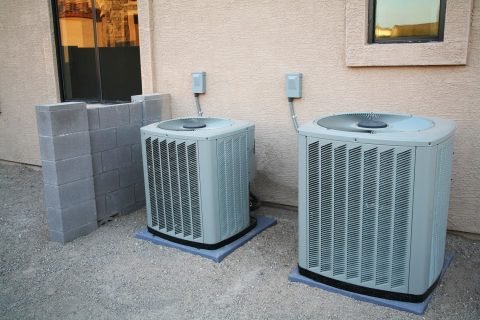 Two-air-conditioner-condensers-outiside-a-house Best Cooling Services In North Andover, MA