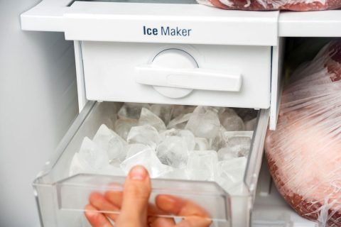 Woman-taking-ice-from-the-ice-maker