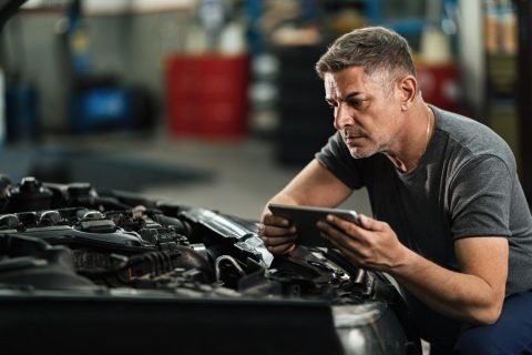 car-mechanic-using-digital-tablet-while-repairing-analyzing-engine-auto-repair-shop car-mechanic-using-digital-tablet-while-repairing-analyzing-engine-auto-repair-shop