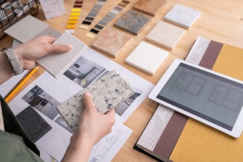 hands-young-female-designer-holding-two-samples-marble-tile-wooden-table-with-digital-tablet-photos-home-interior-etc
