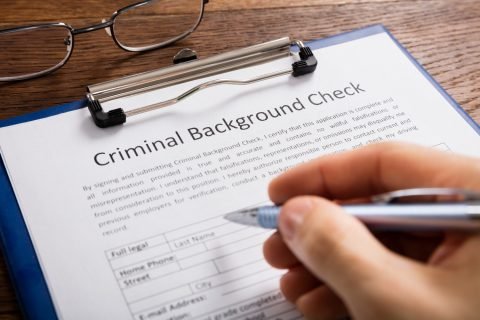 Person Filling Criminal Background Check Application Form Check Investigations