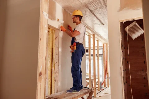 male-builder-painting-wall-in-house-under-construc-2022-01-19-00-13-07-utc-1