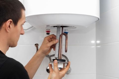 master-installs-a-new-electric-heating-ten-in-a-water-tank master-installs-a-new-electric-heating-ten-in-a-water-tank