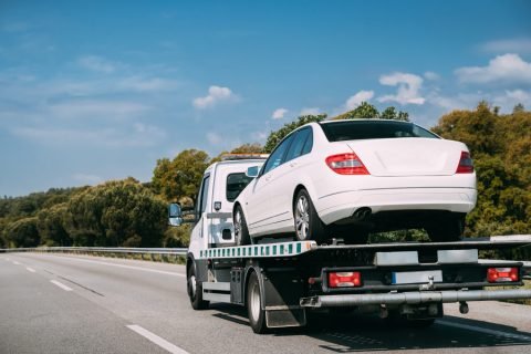 Car,Service,Transportation,Concept.,Tow,Truck,Transporting,Car,On,Motorway Towing Services In Modesto, CA